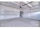 Unfinished garage with concrete floor, water heater and door to the home at 107 Megby Trl, Statesville, NC 28677