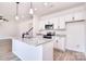 Modern kitchen featuring a granite island, stainless steel appliances and white cabinets at 107 Megby Trl, Statesville, NC 28677