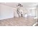 Open-concept living room and kitchen area with hardwood floors, natural light, and a staircase at 107 Megby Trl, Statesville, NC 28677