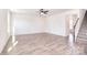 Bright living room featuring wood-look flooring, ceiling fan, and an open floor plan at 107 Megby Trl, Statesville, NC 28677