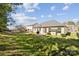 Spacious backyard with lush green grass, mature trees, and a cozy patio area at 1121 Mckee Farm Ln, Belmont, NC 28012