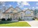 Charming two-story home with a well-manicured lawn and a welcoming entrance and two-car garage at 1121 Mckee Farm Ln, Belmont, NC 28012
