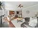 Open-concept living room with hardwood floors, a fireplace, and views into the kitchen and dining area at 1121 Mckee Farm Ln, Belmont, NC 28012