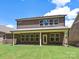 The backyard has a covered patio and a well-manicured lawn at 13126 Macon Hall Dr, Mint Hill, NC 28227