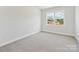 Bright bedroom featuring carpet floors and a window with a view of the neighborhood at 13126 Macon Hall Dr, Mint Hill, NC 28227