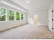 Bright bedroom with large windows offering scenic views of the outdoors, plus an attached bathroom at 13126 Macon Hall Dr, Mint Hill, NC 28227