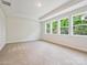 Bright bedroom with carpet floors and large windows offering scenic views of the outdoors at 13126 Macon Hall Dr, Mint Hill, NC 28227