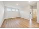 Spacious bonus room with three windows offering plenty of natural light and wood-look flooring at 13126 Macon Hall Dr, Mint Hill, NC 28227