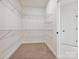 Walk-in closet with ample storage space, featuring multiple shelves and rods for organized clothing storage at 13126 Macon Hall Dr, Mint Hill, NC 28227