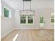 Bright dining area with recessed lights and a modern light fixture, with an entrance to backyard at 13126 Macon Hall Dr, Mint Hill, NC 28227