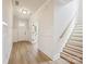 Bright foyer featuring hardwood floors, paneled walls, and a staircase at 13126 Macon Hall Dr, Mint Hill, NC 28227
