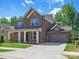 This home features a brick exterior, a two-car garage, and a well-maintained lawn at 13126 Macon Hall Dr, Mint Hill, NC 28227