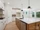 Modern kitchen with white cabinetry, stainless steel appliances, and a large island with seating at 13126 Macon Hall Dr, Mint Hill, NC 28227