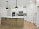 Modern kitchen with white cabinets, stainless steel appliances, and a large island at 13126 Macon Hall Dr, Mint Hill, NC 28227