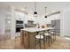 Spacious kitchen featuring white cabinets, stainless steel appliances, and a center island with seating at 13126 Macon Hall Dr, Mint Hill, NC 28227