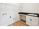 The laundry room includes wooden floors, a sink, a black countertop, and storage cabinets at 13126 Macon Hall Dr, Mint Hill, NC 28227