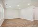 Expansive living room features wood flooring and recessed lights, complemented by bright, natural light at 13126 Macon Hall Dr, Mint Hill, NC 28227