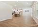 Open-concept space featuring wood flooring, natural light, and a modern kitchen view at 13126 Macon Hall Dr, Mint Hill, NC 28227