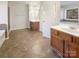 Bright bathroom featuring double vanity sinks, tile floors, and natural light at 13903 Mallard Roost Rd, Charlotte, NC 28262