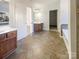 Bright bathroom featuring double vanities, a large mirror and tiled floors at 13903 Mallard Roost Rd, Charlotte, NC 28262