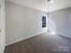 Cozy bedroom featuring neutral carpet, light walls, and a bright window at 13903 Mallard Roost Rd, Charlotte, NC 28262