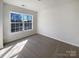 Comfortable carpeted bedroom with a bright window and natural light at 13903 Mallard Roost Rd, Charlotte, NC 28262