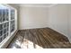 Cozy bedroom with hardwood floors, a large window, and natural light at 13903 Mallard Roost Rd, Charlotte, NC 28262