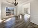 Bright dining room with updated floors, trim detail, and modern lighting fixture at 13903 Mallard Roost Rd, Charlotte, NC 28262