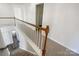 Upstairs hallway featuring hardwood railing, carpeted floors, and natural light at 13903 Mallard Roost Rd, Charlotte, NC 28262