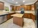 Modern kitchen featuring stainless steel appliances, granite countertops, and central island at 13903 Mallard Roost Rd, Charlotte, NC 28262