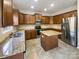 Well-equipped kitchen features stainless appliances, granite countertops, and custom cabinets at 13903 Mallard Roost Rd, Charlotte, NC 28262