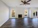 Spacious living room offering dark wood floors, a fireplace, and lots of natural light at 13903 Mallard Roost Rd, Charlotte, NC 28262