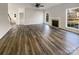 Open-concept living room featuring wood flooring, fireplace, and natural light at 13903 Mallard Roost Rd, Charlotte, NC 28262