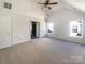 Spacious primary bedroom offering neutral carpet, a ceiling fan, and large windows at 13903 Mallard Roost Rd, Charlotte, NC 28262