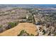 An aerial view showcases this property and its natural wooded surrounding landscape at 14325 Rocky River E Rd, Davidson, NC 28036