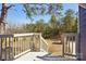 View of the backyard from a deck with stairs, showing the wooded landscape at 14325 Rocky River E Rd, Davidson, NC 28036