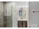 Modern bathroom features white and gray tile, new vanity, and updated fixtures at 14325 Rocky River E Rd, Davidson, NC 28036