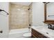 Stylish bathroom features a shower-tub combination with tiled walls and dark oil rubbed bronze fixtures at 14325 Rocky River E Rd, Davidson, NC 28036