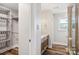 Bathroom featuring walk-in shower with tiled walls, a toilet, wood look floors and double sink vanity at 14325 Rocky River E Rd, Davidson, NC 28036