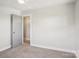 Bedroom featuring carpet flooring and a doorway with a unique light fixture at 14325 Rocky River E Rd, Davidson, NC 28036