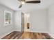 Bright bedroom featuring hardwood floors and a door leading to the updated bathroom at 14325 Rocky River E Rd, Davidson, NC 28036