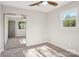 Bright bedroom with gray walls, carpeted floor, ceiling fan and closet with mirrored doors at 14325 Rocky River E Rd, Davidson, NC 28036