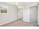 Bright bedroom with gray walls, carpeted floor, ceiling fan and closet with mirrored doors at 14325 Rocky River E Rd, Davidson, NC 28036