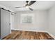 Bedroom with hardwood floors, natural light, and a sliding door to the closet at 14325 Rocky River E Rd, Davidson, NC 28036