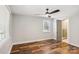 A sunlit bedroom with hardwood floors, white walls, and a view from the window at 14325 Rocky River E Rd, Davidson, NC 28036