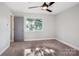 A bright, airy bedroom features a ceiling fan, window, and neutral carpeting at 14325 Rocky River E Rd, Davidson, NC 28036