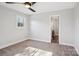 A spacious bedroom offers neutral colored walls, ceiling fan and a bright window at 14325 Rocky River E Rd, Davidson, NC 28036