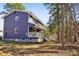 Exterior view of the house featuring a porch, siding, and some beautiful landscaping at 14325 Rocky River E Rd, Davidson, NC 28036