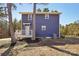 Two-story home with blue siding, deck, and landscaped yard at 14325 Rocky River E Rd, Davidson, NC 28036