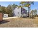 Two-story home with blue siding, white trim, and deck at 14325 Rocky River E Rd, Davidson, NC 28036